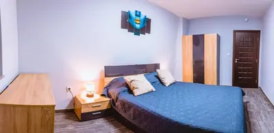 a bedroom with a blue bed and a night stand at Boutique 1-bedroom flat in the heart of the city in Plovdiv