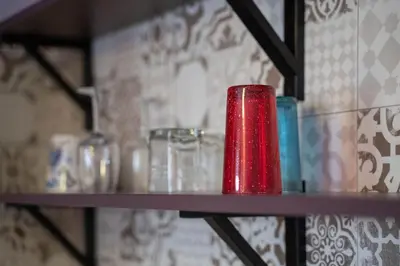 a red container sitting on top of a shelf at Spacious apartment in the heart of Studentski grad in Sofia