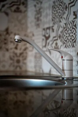 a metal sink with a faucet in a bathroom at Spacious apartment in the heart of Studentski grad in Sofia