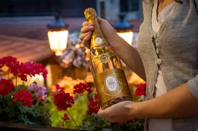 a woman is holding a bottle of champagne at Хотел Том и Нези Класик in Velingrad