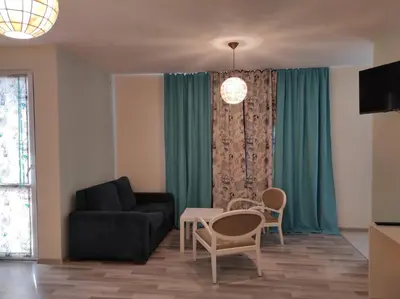 a living room with a couch and a table and chairs at BeLApartment in Petrich