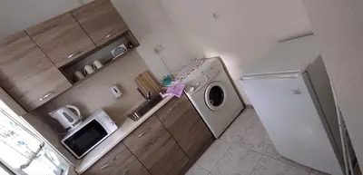 a kitchen with a washing machine and a refrigerator at BeLApartment in Petrich