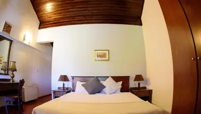 a bedroom with a bed and a wooden ceiling at Self Catering Chalet Kulina in Bansko