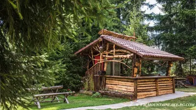 a gazebo in a park with a bench at Studio 6,Smolyan lakes in Smolyan