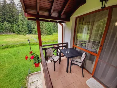 a patio with a table and chairs on a porch at Studio 6,Smolyan lakes in Smolyan