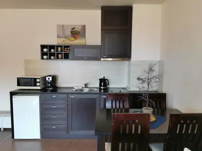 a small kitchen with a table and a microwave at **Mountain** views just next to the gondola lift in Bansko