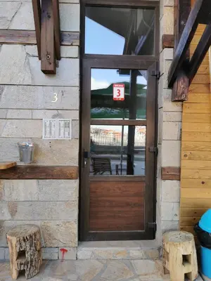 a door to a building with a sign on it at **Mountain** views just next to the gondola lift in Bansko