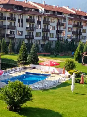 a large apartment building with a swimming pool at **Mountain** views just next to the gondola lift in Bansko