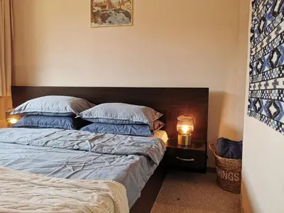 a bedroom with a bed and a lamp on a table at **Mountain** views just next to the gondola lift in Bansko