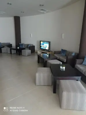 a living room with couches and tables and a tv at Апартамент-студио в Банско-Разлог,Aspen Golf- C206 in Bansko