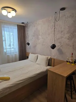 a bedroom with a bed and a desk and lights at Студио Пампорово Палас - Pamporovo Palace in Pamporovo