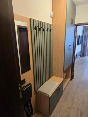 a dressing room with a bench in a room at Студио Пампорово Палас - Pamporovo Palace in Pamporovo