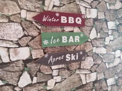 two street signs on a stone wall at Ски студио Снежанка в Грийн лайф Пампорово in Pamporovo