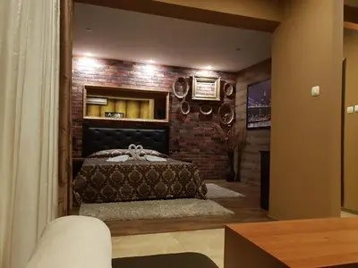 a bedroom with a bed in a brick wall at Guest House Amore in Sandanski