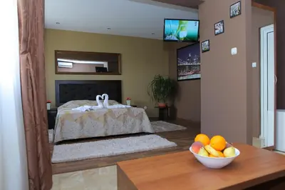 a living room with a bed with a bowl of fruit at Guest House Amore in Sandanski
