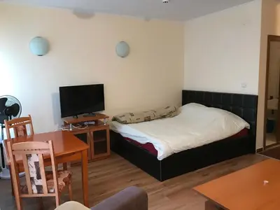 a bedroom with a bed and a tv and a table at Ski Zone at Gondola, Perfect, Fast WiFi, Quiet, Warm in Bansko