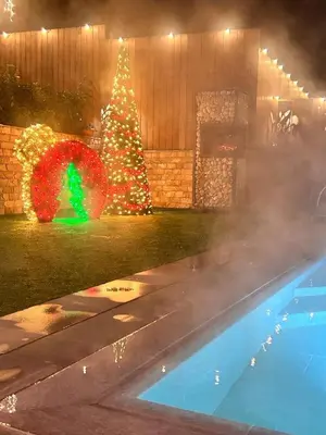 a christmas tree and a swimming pool with a fire hose at Guest house Wishmore in Banya