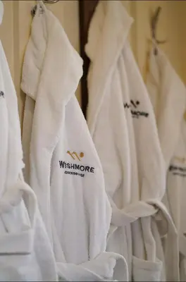 a group of white towels hanging in a closet at Guest house Wishmore in Banya