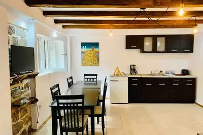 a kitchen with a table and chairs in a kitchen at Villa Aquila in Beli Iskar