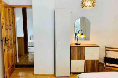 a bedroom with a bed and a dresser and a mirror at Villa Aquila in Beli Iskar