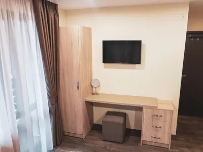 a room with a desk and a tv on the wall at Къща за гости Амая - Сандански in Sandanski