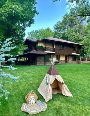 a tent in the yard in front of a house at Къща за гости Амая - Сандански in Sandanski
