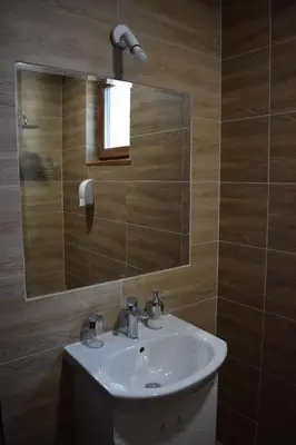 a bathroom with a sink and a mirror at Къща за гости Шошови in Velingrad