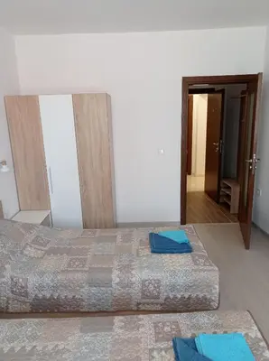 a bedroom with two beds with blue towels on the floor at Къща за гости Шошови in Velingrad
