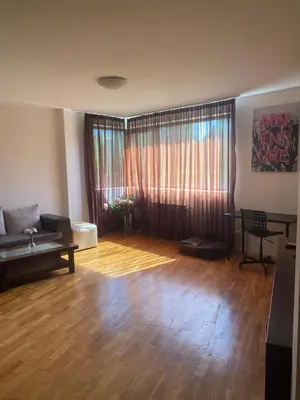 a living room with a couch and a table at K's Place Apartment Pravets Golf Resort in Pravets