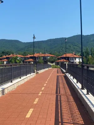 a bridge over a river with houses on it at K's Place Apartment Pravets Golf Resort in Pravets