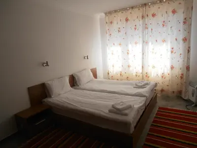 a small bed in a room with a window at Monastery 3 Apartments TMF in Pamporovo