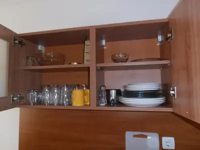 a cupboard with plates and dishes in it at Monastery 3 Apartments TMF in Pamporovo