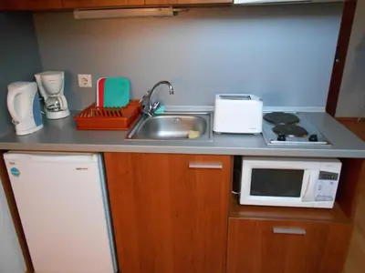 a kitchen counter with a sink and a microwave at Studio Villa Park 408 in Borovets