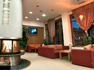 a living room with couches and a fire place at Studio Villa Park 408 in Borovets