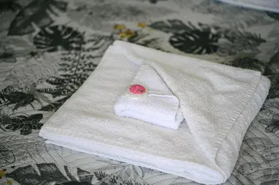 a white towel sitting on top of a bed at AMAZING view, privacy and comfort - SPA Villa Krasi in Blagoevgrad