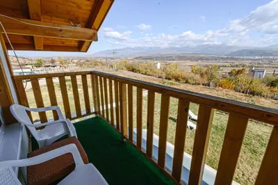 a balcony with two chairs and a view of the desert at AMAZING view, privacy and comfort - SPA Villa Krasi in Blagoevgrad