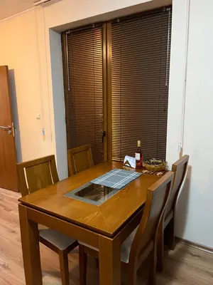 a dining room table with a laptop on top of it at Ski Zone at Gondola, Warm and Cosy, WiFi, AC, Netflix, Perfect One Bedroom appartment, Beautiful View in Bansko