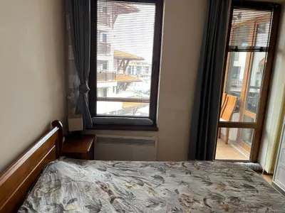 a bedroom with a bed and a large window at Ski Zone at Gondola, Warm and Cosy, WiFi, AC, Netflix, Perfect One Bedroom appartment, Beautiful View in Bansko