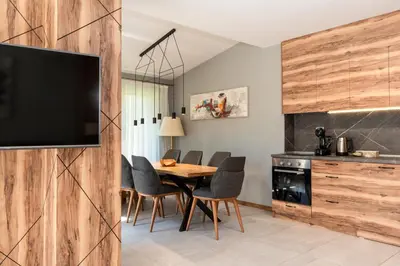 a kitchen and dining room with a table and chairs at Kleptuzaparts in Velingrad