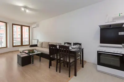 a living room with a couch and a table at Modern and Bright Apartments near Center - FREE PARKING in Sofia