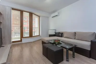 a living room with a couch and a table at Modern and Bright Apartments near Center - FREE PARKING in Sofia