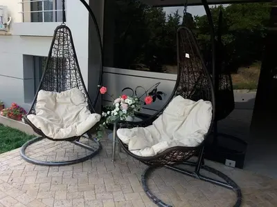 two chairs with flowers in them on a patio at Хотел Дани in Sandanski