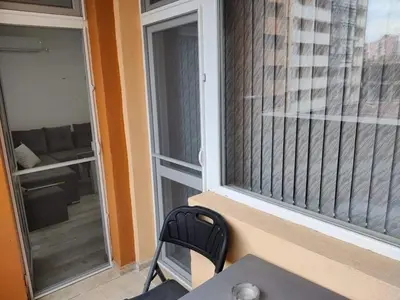 a chair sitting next to a sliding glass door at Apartment Anelia 3 in Plovdiv