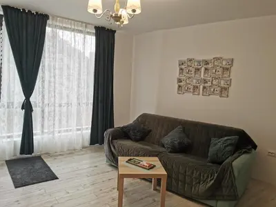 a living room with a couch and a table at Retro Studio byPMM in Plovdiv