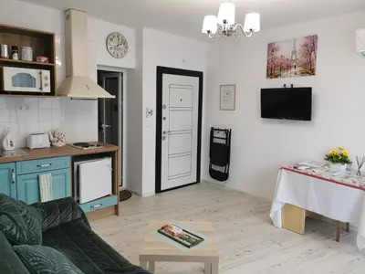 a living room with a couch and a table at Retro Studio byPMM in Plovdiv