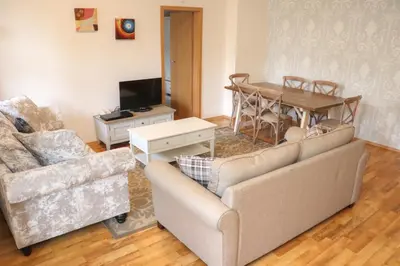 a living room with two couches and a table at Mountain View Aparthotel in Bansko