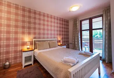a bedroom with a bed with two towels on it at Mountain View Aparthotel in Bansko