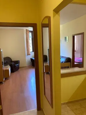 a living room with yellow walls and a mirror at Flora Apartment 613 in Borovets