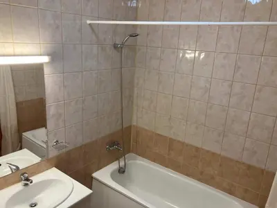 a bathroom with a shower and a sink and a tub at Flora Apartment 613 in Borovets