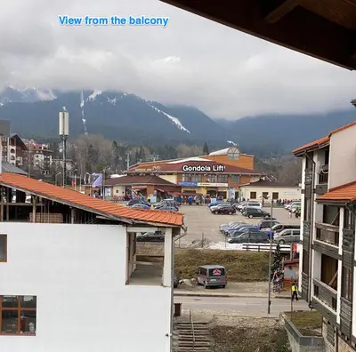 a view of a town with a snow covered mountain at Large Gondola Apartment - Center, Neon in Bansko